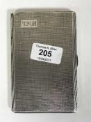 A silver cigarette case with engine turned decoration,