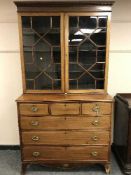 A George III style inlaid mahogany bookcase,