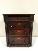 A 19th century miniature four drawer chest in the form of a lobby chest