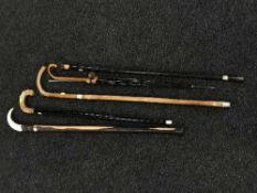 A collection of walking sticks and umbrellas - Silver topped walking cane,
