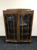 A mahogany display cabinet on claw and ball feet
