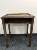 An early twentieth century carved oak book table