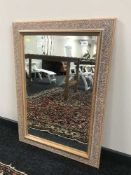 A contemporary carved framed mirror