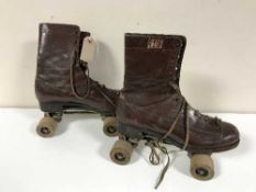 A pair of vintage leather rollers skates