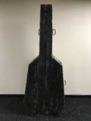 An antique pine cabinet in the form of a double bass case