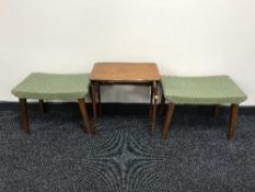 A pair of teak dressing table stools and a side table
