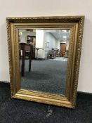 An early twentieth century bevelled over mantle mirror in heavy gilt frame