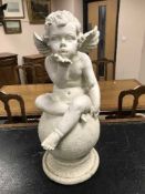 A cherub garden figure,