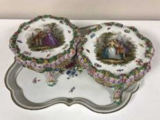A pair of Meissen porcelain table stands painted with lovers in a garden,