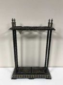 An antique cast metal stick stand with stick trays