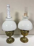 Two brass Aladdin oil lamps with chimneys and shades