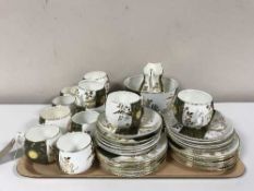 A tray of antique forty piece green and white tea service
