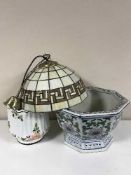 Two pottery jardinieres with stands and a Tiffany style light shade