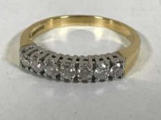An 18ct gold seven stone diamond ring