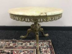 A circular marble topped table on a gilt three way pedestal