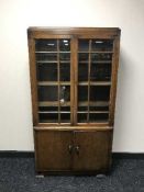A double door oak glazed bookcase