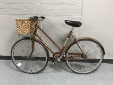 A lady's Raleigh bike with wicker shopping basket