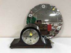 An oak cased mantel clock with silvered dial and an un-framed circular mirror