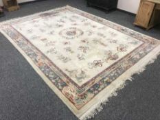 A large fringed Chinese carpet on cream ground