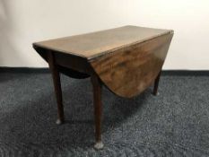 An antique mahogany drop leaf table