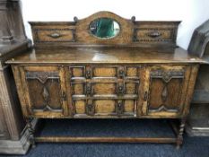 A carved oak mirror backed sideboard