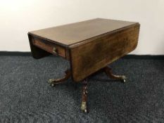 A Victorian mahogany flap sided table on four way support