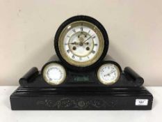 A Victorian black slate mantel clock with enamelled dial thermometer & barometer apertures