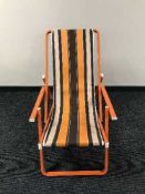 A folding metal deck chair