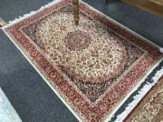 A fringed Persian Keshan rug on red ground 190 cm x 140 cm