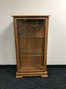 A teak effect glazed door display cabinet