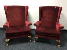 A pair of red buttoned dralon wing backed chairs