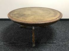 A leather topped coffee table and a mahogany dining chair