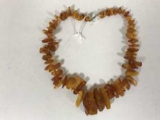 An amber necklace with 9ct gold clasp