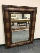 A leather effect bevelled mirror