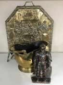 A brass embossed fire screen together with a brass standard lamp and shade,