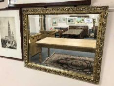 An early 20th century bevelled gilded mirror, 45 cm x 34 cm.