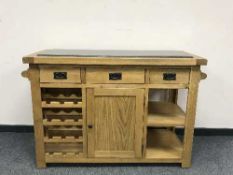 A good quality light oak kitchen island with black granite top, width 130 cm x 60 cm,