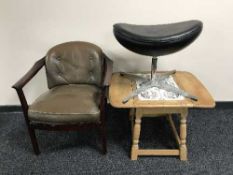 A 1970's armchair with brown buttoned leather cushions,