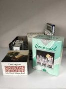 A box containing a large quantity of boxed china including stainless steel serving trays,