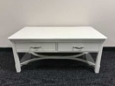 A white coffee table fitted two drawers,