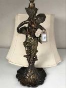 A patinated spelter figural table lamp with shade