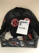 A basket of a 1991 Malcolm X world tour jacket, pair of New Balance kids football boots,