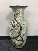 A large oriental pottery vase depicting birds and foliage