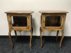 A pair of French ormolu mounted glazed side cabinets