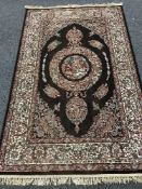 A fringed Persian carpet of zoomorphic design,