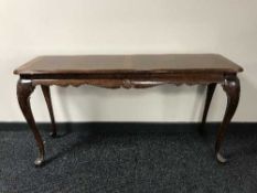 A mahogany console table on ball and claw feet