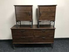 A contemporary walnut effect four drawer chest with matching bedside stands