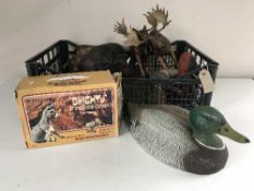 A basket of plastic animal ornaments - bison, stag, decoys,