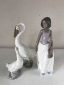 A Nao figure of a girl and two Nao swans