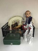 A crate containing cash box with key, wooden cat ornaments, 1950's doll,